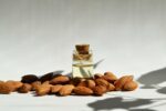 Almond,Oil.,Oil,In,A,Glass,Bottle,And,Almond,Nuts.